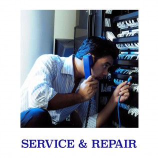 man with a blue phone to his ear adjusting telecom equipment